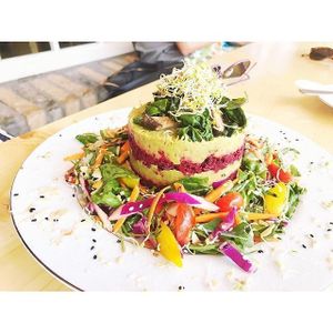 Delicious Beetroot Tart, with a pecan nut flax seed and tarragon base, layered with beetroots, leeks, spinach and shiitake mushrooms, served with salad and such a delicious dressing. Licked the plate clean. Such beautiful nutritional food. Happy heart happy body. Thank you.  at Soul Foods in Western Cape