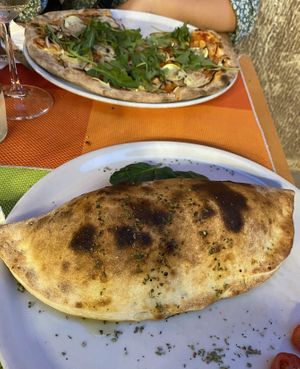 Vegan Pizza with Rocket salad and the calzone with mincemeat  at Sa Cova in Mallorca