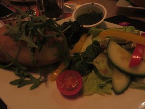 vegan version of oven-baked potato with spinach, mojo verde (garlic dip) and a side salad  at Celona in Saarbrucken