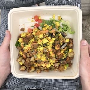 (Tofu) Scram Bowl: With tofu, roasted potatoes, roasted vegan sausage, tomato, romaine, lots of turmeric and spices and yummy vegan dressing. (Served for breakfast before 12pm.) at Living on the Veg in Beach Haven