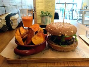 Quinoa burger with patatas fritas, vegan tartare sauce and juice of the day.  at Quinoa Arago Vegetaria in Barcelona