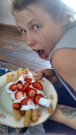 Churros with strawberries and whipped cream at The Churro Bar & Vegan Bakery in Cusco