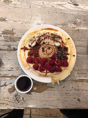 Sourdough waffle with fruits and almond butter  at Carmel by the Green in East London