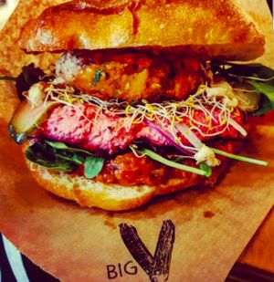 Spicy British Yellow Pea burger with beetroot humus, live bean sprouts and leaves at Big V - Greenwich Market Food Stand in South East London