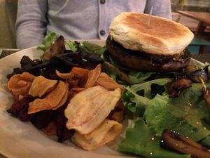 Portobello hamburguer with caramelised onion, vegetable chips and salad (10 euros) at Bruta Flor in Lisbon