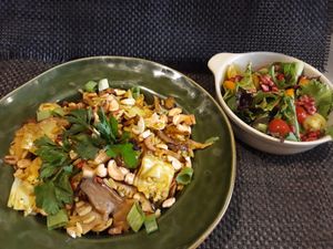 Paella with shitake articokes and cashew. Salad with pomegranate, cherry tomato and physalis at Bruta Flor in Lisbon