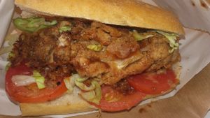 One of Hygge Food sandwhichs, Southern fried cornmeal crumb cauliflower weengs, bbq sauce, mayo, with tomato & lettuce!  at The Cran in Glasgow