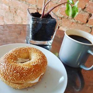Fresh baked bagel with vegan cream cheese at The Hearty Hooligan in Hamilton