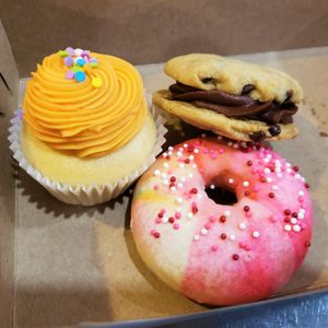 Creamsicle cupcake, chocolate chip cookie sandwich, and baked vanilla donut with vanilla frosting. at The Hearty Hooligan in Hamilton