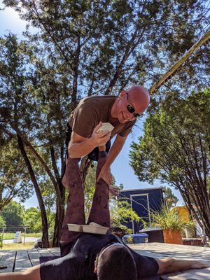 Acroyoga on the adjacent stage with a Revolution wrap. at Revolution Vegan Kitchen in Austin