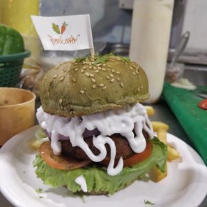 Our Matcha tandoori burger so good. at Rare Earth Cafe & Organic Store in Mumbai