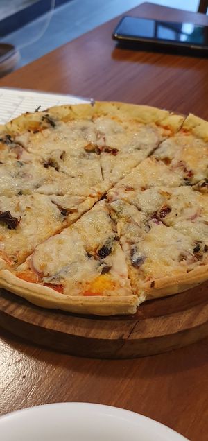 Delicious vegan cheese on pizza - the veggie toppings could've been more generous. at Rare Earth Cafe & Organic Store in Mumbai