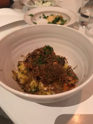 A bed of potatoes with chantarelles and magical truffels on top at Rutabaga in Stockholm