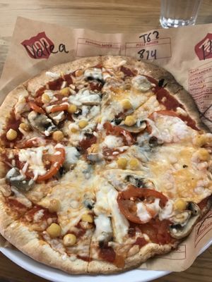 Pizza with mushrooms, chickpeas, tomatoes and vegan cheese at Mod Pizza in London