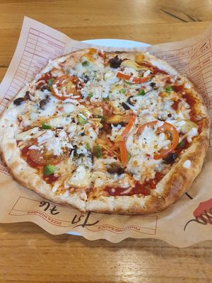 Make your own pizza with vegan cheese, garlic, artichokes, olives, tomatoes and green peppers at Mod Pizza in London
