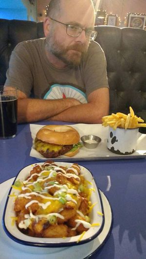 Jackfruit burger thing and tator tots in a bed pan at The Footage in Manchester