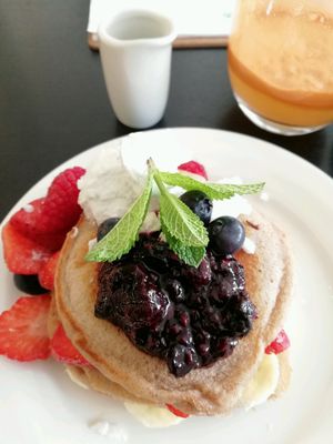 Pancake stack with fresh berries and coconut yoghurt.  at Retreat Kitchen in Richmond Upon Thames