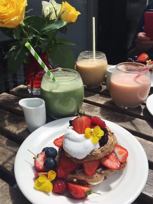 Cinnamon and banana pancake stack served with maple syrup at Retreat Kitchen in Richmond Upon Thames