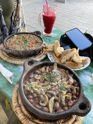 Bean and mushroom tagline (closest) and veggie lentil tagline with orange beet juice   at Le Corail at Latifa in Essaouira