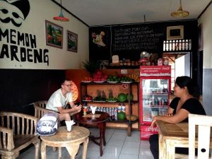 Seating area, 2 more tables not in picture. Fruit shelf full of local produce at Memoh Warung in Canggu