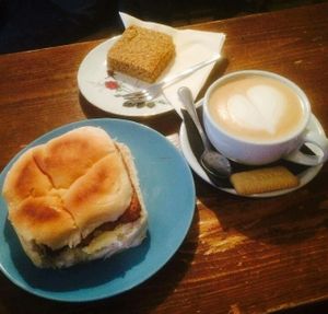 vegan soy latte, sausage sandwich and flapjack at Just Desserts & Coffee  in Hull