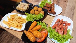 (clockwise from left) French fries, Vietnamese yam rolls, Goro mashed potato balls, burdock spring rolls, Nom Nom soy sausages, sugarcane drumsticks at NomVnom - Tai Seng in Central Singapore