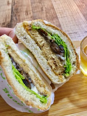 Lions mane patty with sautéed button mushrooms. White truffle sauce. Coral lettuce. $9.90 at NomVnom - Tai Seng in Central Singapore