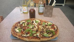 vegan pizza, chili oil and drinks at Organic Pizza in Salzburg