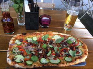 Pizza with vegan cheese, zucchini, peppers, onions, mushrooms and olives at Organic Pizza in Salzburg