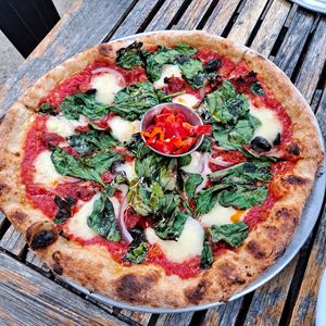 Bad Motorfinger Pizza: Crushed tomato, mozzarella (house made from white beans,) sun dried tomato, 'nduja pickled peppers, red onions, olives, spinach😋 at Donna Jean in San Diego
