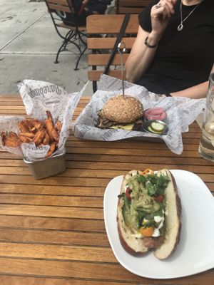Beyond Dog on a pretzel bun and a bean burger with vegan cheese+wild shrooms  at Bareburger in Rye
