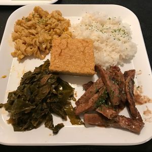 Jerk Chickin with collard green, mac and cheese, corn bread, and rice at Soul Good Vegan Cafe in Durham