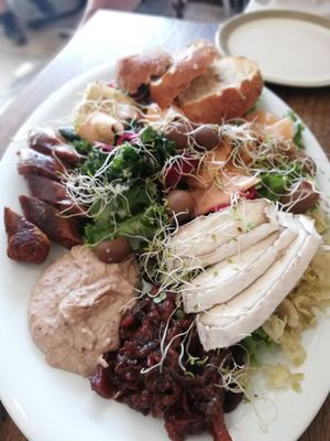 Salad, hummus, cashew camembert, spicy oat sausage, olives, melon at Tea and Happiness in Rotorua