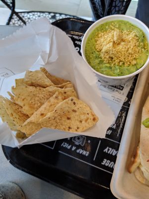 Kale artichoke dip with tortilla chips at By Chloe - Seaport Blvd in Boston