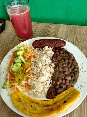 Black beans, whole grain rice, salad, veggie sausage, banana slice at Semillas Comida Sana in Pereira