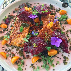 House made temph with black tahini and edible flowers  at Confluence Kombucha in St Louis