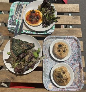 Pizza (top), green quiche (left), focaccias with olives (right)  at Maisie Cafe in Paris