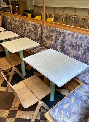 Part of the interior seating space at Maisie Cafe in Paris