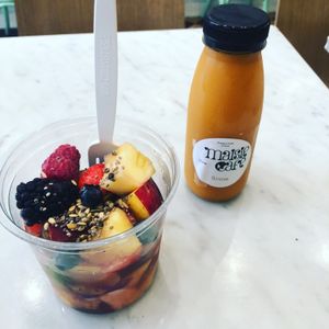 Fruit bowl, carrot juice  at Maisie Cafe in Paris