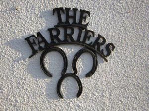 The Farriers Logo on the wall outside at The Farriers Vegan Bed & Breakfast in Kouklia