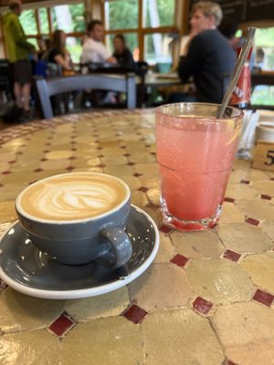 Flat white with oat milk and a homemade pink lemonade  at Caffi Caban Cafe in Brynrefail