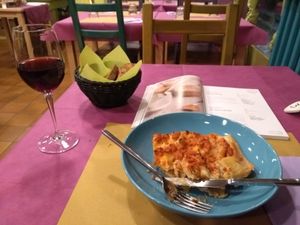 Lasagna, red wine (also vegan) and lots of vegan recipe books to look through. at Cardamomo Cucina Vegana in Arona