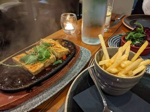 Teriyaki tofu sizzler with fries and a side of olives at Casa Mia in Dumfries