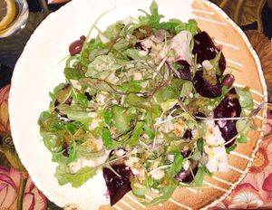 Vegan salad with arugula/rocket, green leaves, almond flakes, wild garlic, olives, red beet and nice vinegar at Sowa in Bydgoszcz