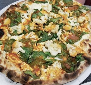 vegan buffalo cauliflower and spinach pizza at Stoked Wood Fired Pizza in Brookline