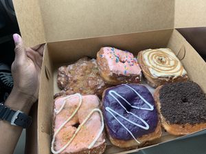 L-R from top: Apple fritter, strawberry frosting, caramel mocha, strawberry cheesecake, sweet potato, Oreo at Valkyrie Doughnuts in Orlando