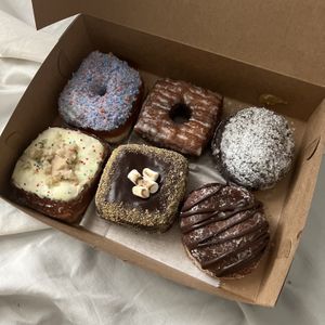 cotton candy, cronut, blueberry lemon filled, birthday cake, s’mores, chocolate filled   at Valkyrie Doughnuts in Orlando