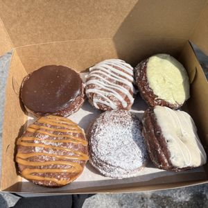 orlando cream, guava cheese, pistachio raspberry, caramel apple, blueberry filled, miso banana  at Valkyrie Doughnuts in Orlando