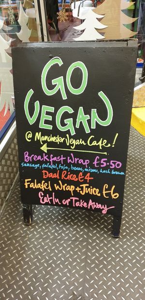 Outdoor sign at Manchester Vegan Cafe in Manchester