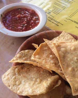 Chips and salsa while we read the menu. Extensive vegan options (well labeled) on simple yellow laminated paper menus. at Hugo's Cocina  in San Diego